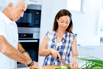 Married couple cooking at home