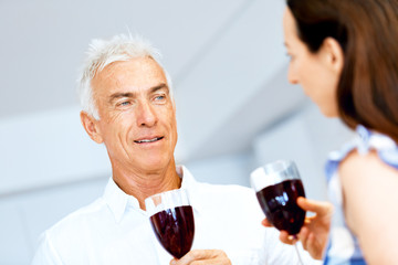 Portrait of a couple having a glass of red wine