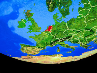 Netherlands from space on model of planet Earth with country borders.