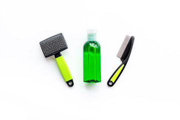 Pet accessories for care and training. Brushes on white background top view mock-up
