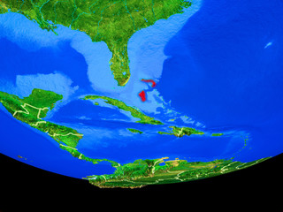 Bahamas from space on model of planet Earth with country borders.