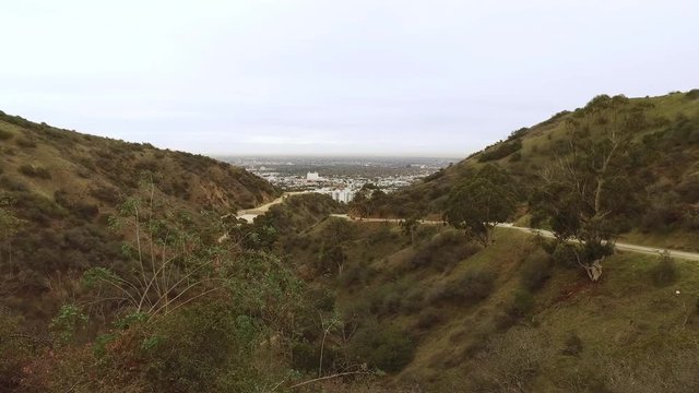 A wide overview establishing shot of Runyon Canyon in the hills of Los Angeles on an overcast day.  	