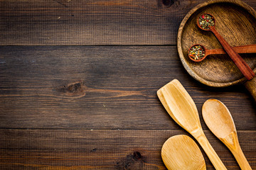 Woodenware set with pan, spoons on wooden background top view mock up