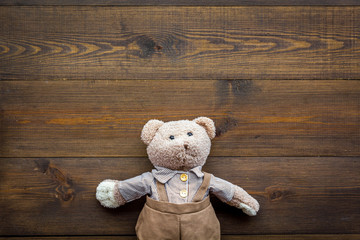 Obraz premium Baby care with craft toys for newborn. Teddy bear. Wooden background top view copy space