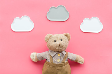 Baby care with craft toys for newborn. Teddy bear. Pink background top view
