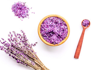 Obraz na płótnie Canvas Aromatherapy. Purple spa salt near dry lavender branches on white background top view