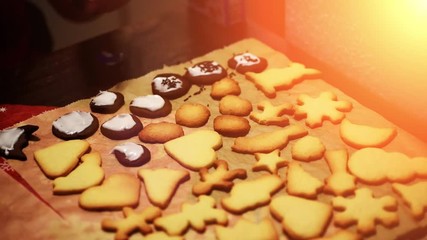 Placing decorations onto freshly baked christmas cookies