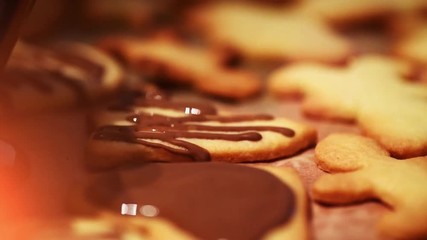 Close up of chocolate drizzle over fresh baked christmas cookies