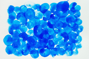 Blue painted on white paper. Abstract background.