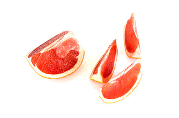 Fresh whole and sliced grapefruit on white background.