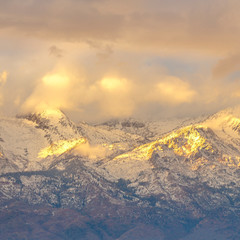 Bright sunlight and puffy clouds at Lone Peak Utah