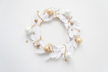 Christmas wreath made of white paper on white background