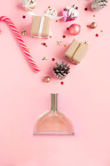Perfume bottle on pink background. Flat lay