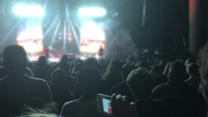 Silhouettes of People in the Bright Lights of a Concert 4K