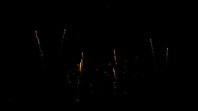 Shimmering golden firework shooting up in the sky in celebration night