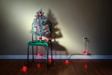 Vintage Christmas tree on an old green metal chair with vintage bubble lights