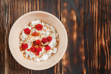 Cottage cheese with raspberries and honey. Top view. Copy space
