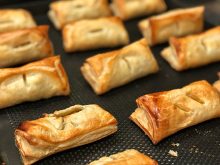 Homemade Puff pastry with pineapple jam, chicken curry , purple potato on black bake tray. Bakery for party , Delicious and unhealthy