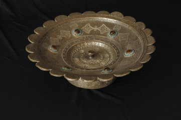ancient metal bowl on dark background. antique bronze tableware