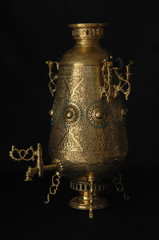 shiny samovar engraved on a black background