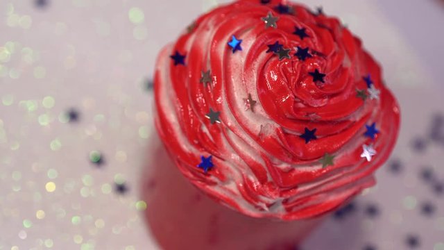 Holiday rad cupcake with the stars. White shiny background. Rotation