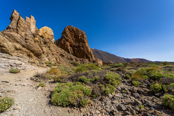 The lava fields of Las Canadas caldera of Teide volcano and rock formations - Roques de Garcia. Tenerife. Canary Islands. Spain.