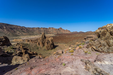 The lava fields of Las Canadas caldera of Teide volcano and rock formations - Roques de Garcia. Tenerife. Canary Islands. Spain.