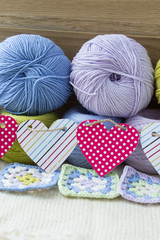 Colorful yarn for knitting, decorated with a garland of hearts.