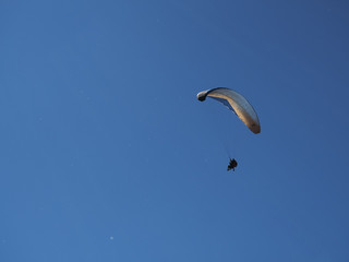 paragliders against the blue sky and mountains