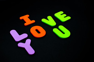 Foam English aphabet letters. I love you with bright letters. Saint Valentine 14 February Concept.