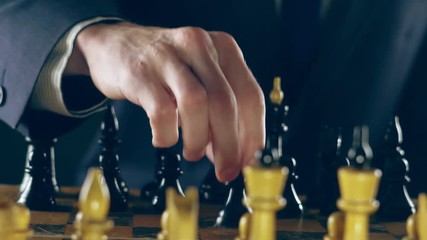 man in a suit playing chess