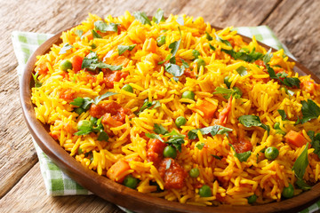 Traditional Indian street food: rice with vegetables close-up on a plate. horizontal