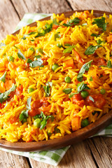 Tawa Pulao is a popular Mumbai street food of rice with vegetables and spices close-up. vertical