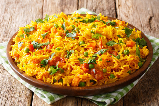 Delicious Indian food Mumbai style rice with vegetables close-up on a plate. horizontal