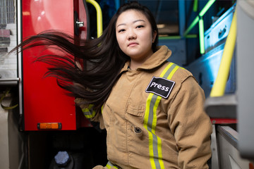 Photo of woman firefighter on background of fire truck