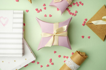 Gift boxes with ribbon on green pastel background with copy space. Minimal cincept of holiday. Top view, spring background