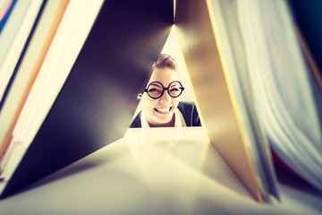 Happy crazy accountant with piles of binders.
