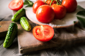 cucumbers, tomatoes and smoke on a black wooden background 5