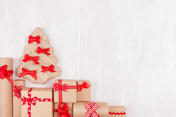 New Year background - handmade christmas tree and gift boxes of kraft paper and red ribbon on white...