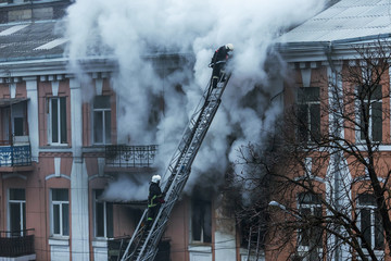  A fire in an apartment building. Strong bright light and clubs, smoke clouds window of their...
