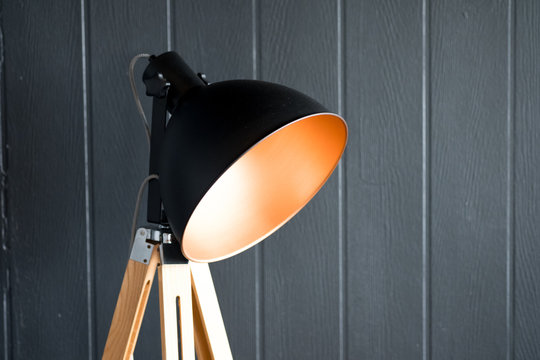 Black lamp shade on gray wall background