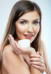 Beauty portrait of smiling girl holding skin cream.