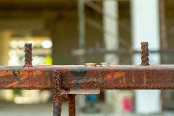 Selective focus on the pile of coins put on the building material. Housing loan concept.