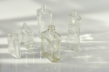 Abstract of light. Afternoon sunlight on vintage bottles collection with white background.