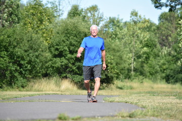 Fototapeta premium Happy Old Senior Grandpa Walking In Park