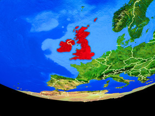 British Isles from space on model of planet Earth with country borders.