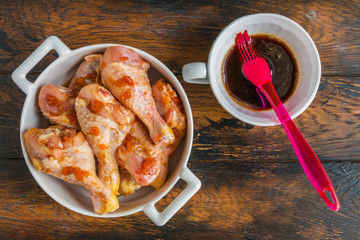 Raw chicken legs marinated in teriyaki, apricot jam, wine vinegar and corn starch sauce. White...