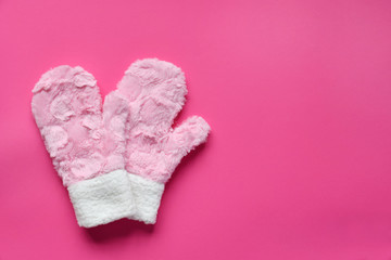 Fur mittens on a pink background. Warm gift or winter comfortable clothes concept. Copy space. Top view