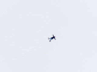 Aerial view of woman lying in snow making snow angel.