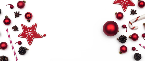 Panorama of Christmas frame of Christmas decorations with fir branches, fir cones, glass balls on white background. Empty space for text. Flat lay, top view. Panoramic